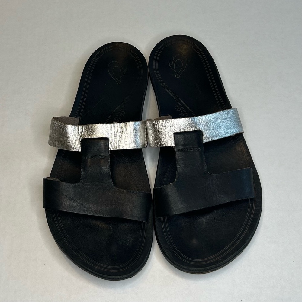 Women's Olukai Size 9W Black and Silver Sandals, Leather Upper, Rubber Soles